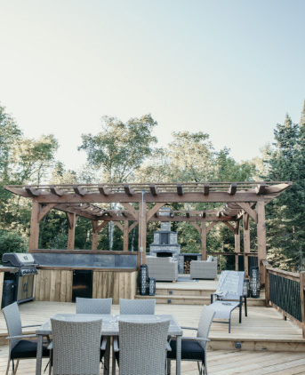 exterior deck with pergola, sitting around, and fireplace