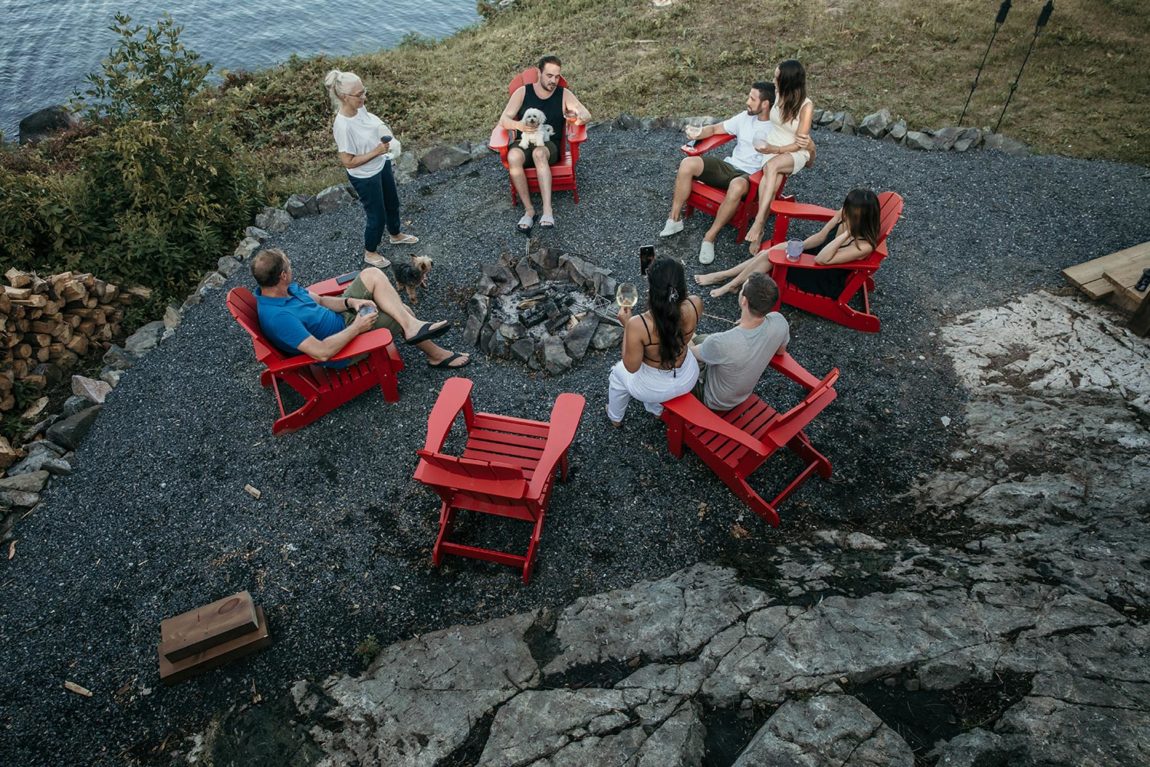 group of people sitting around campfire at adventure island